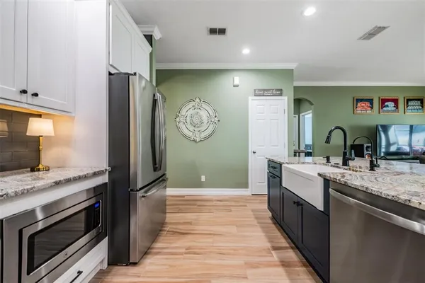 a kitchen with stainless steel appliances granite countertop a stove and a sink