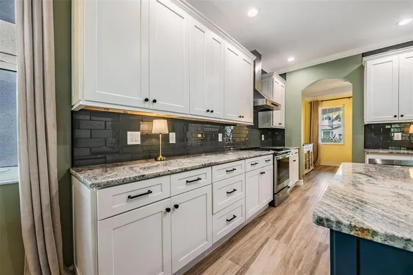 a kitchen with granite countertop cabinets stainless steel appliances and a counter space