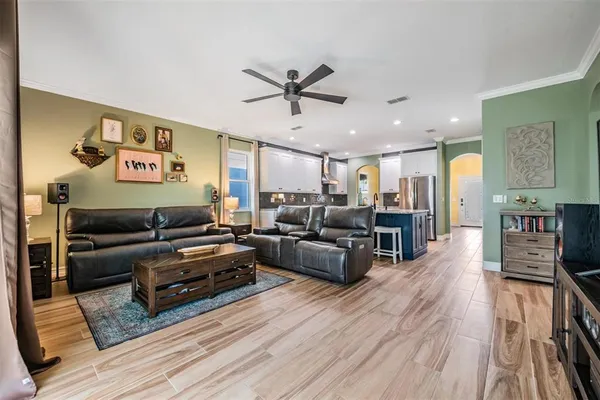 a living room with furniture and wooden floor
