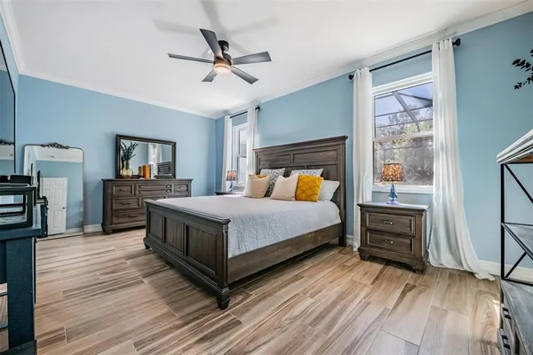 a bedroom with a bed and wooden floor