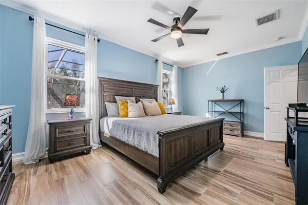 a bed room with a bed and a ceiling fan