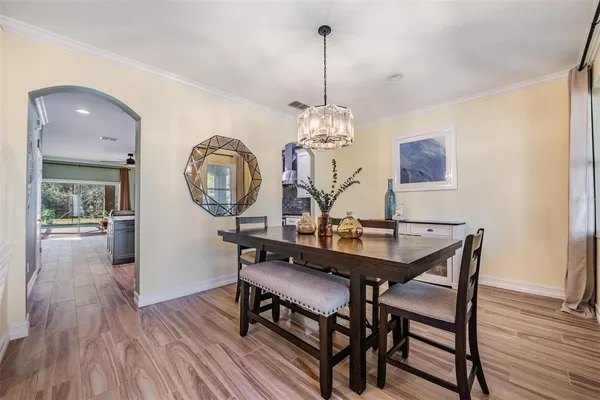 a view of a dining room with furniture and wooden floor