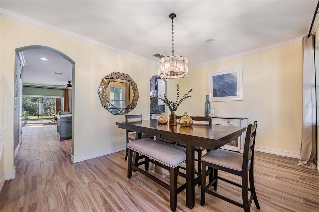 12902 Tikal Way Trinity, FL 34655 - Photo 21 of 43 a view of a dining room with furniture and wooden floor