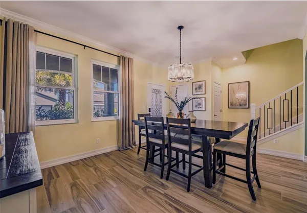 a view of a dining room with furniture window and wooden floor
