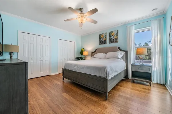 a bedroom with a bed and a chandelier