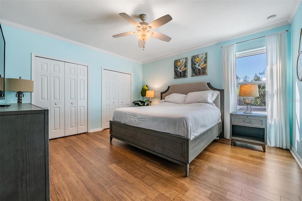 12902 Tikal Way Trinity, FL 34655 - Photo 23 of 43 a bedroom with a bed and a chandelier