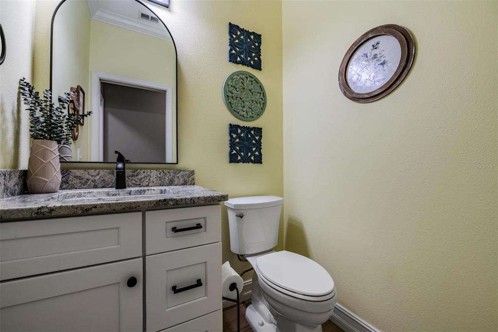 12902 Tikal Way Trinity, FL 34655 - Photo 33 of 43 a bathroom with a toilet a sink and a mirror