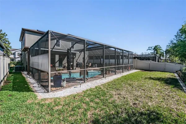 a view of backyard with a garden and deck