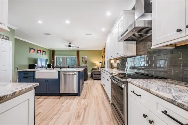 a kitchen with granite countertop stainless steel appliances and white cabinets