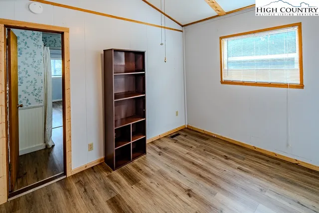 a bedroom with a bed and a potted plant