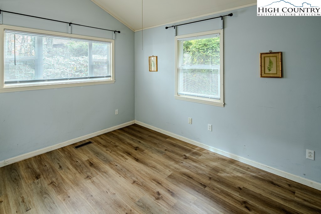 261 Black Pine Road Newland, NC 28657 - Photo 25 of 41 a view of empty room with wooden floor and fan
