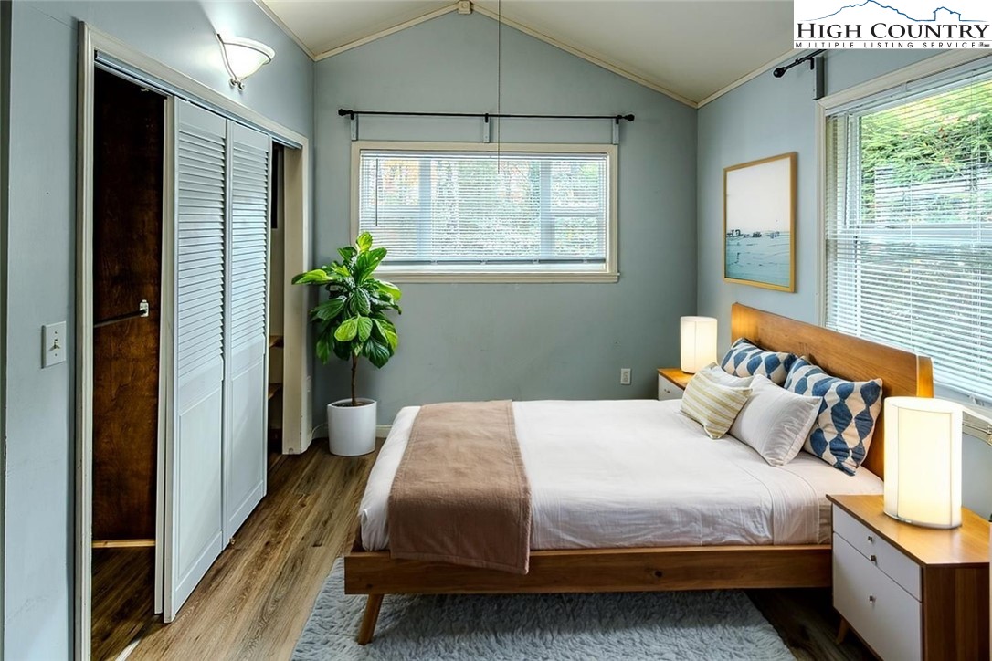 261 Black Pine Road Newland, NC 28657 - Photo 26 of 41 a bedroom with a bed and a potted plant