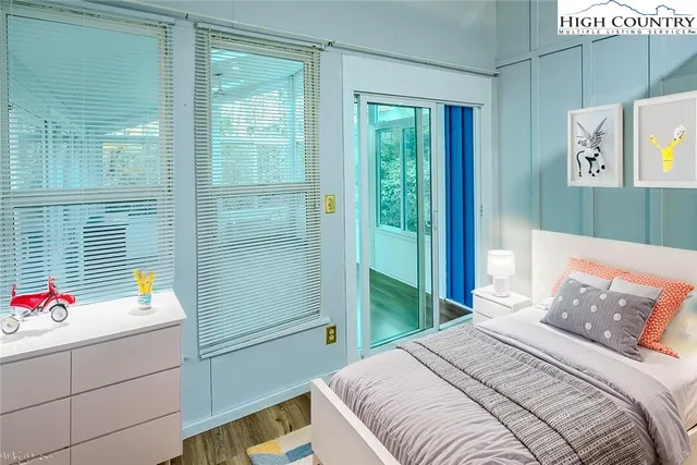 a living room with a fireplace and a floor to ceiling window