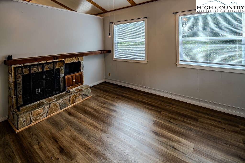 261 Black Pine Road Newland, NC 28657 - Photo 6 of 41 a view of an empty room with wooden floor and a window