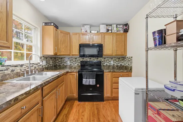 a kitchen with granite countertop a stove and a sink