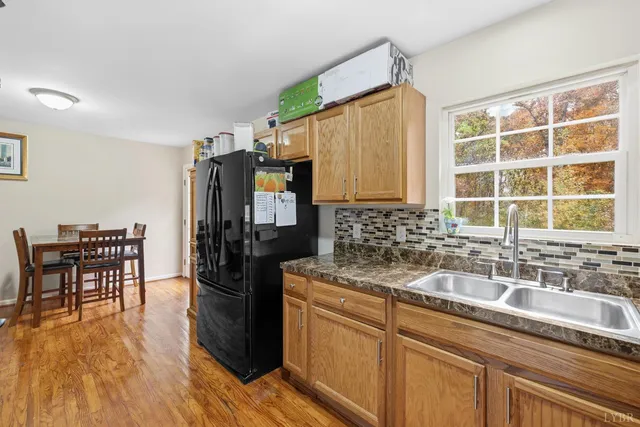 a kitchen with stainless steel appliances granite countertop a sink and wooden cabinets