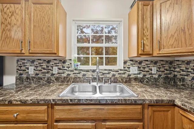 a kitchen with granite countertop a sink and a window