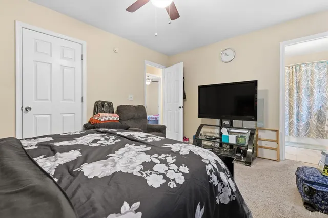 a bedroom with bed and a flat screen tv