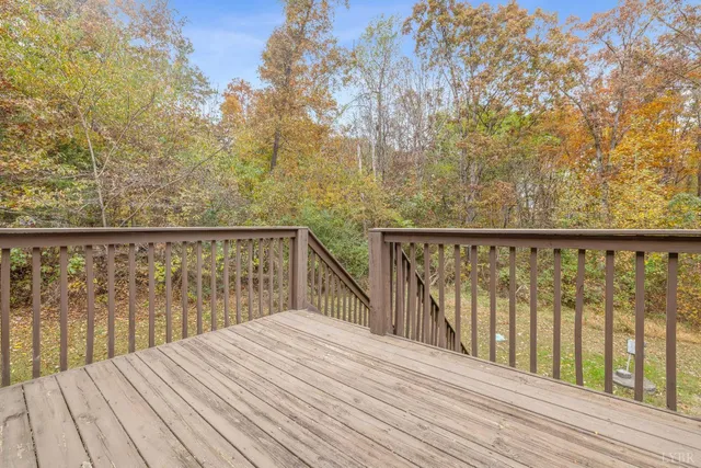 a view of wooden deck and a backyard