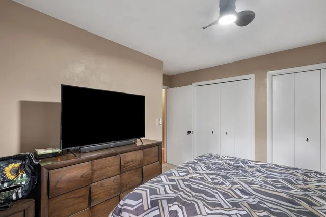 a bedroom with bed and flat screen tv