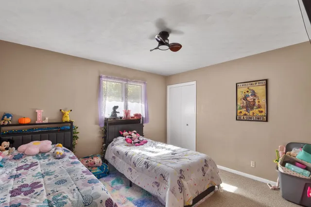 a bedroom with bed and a window