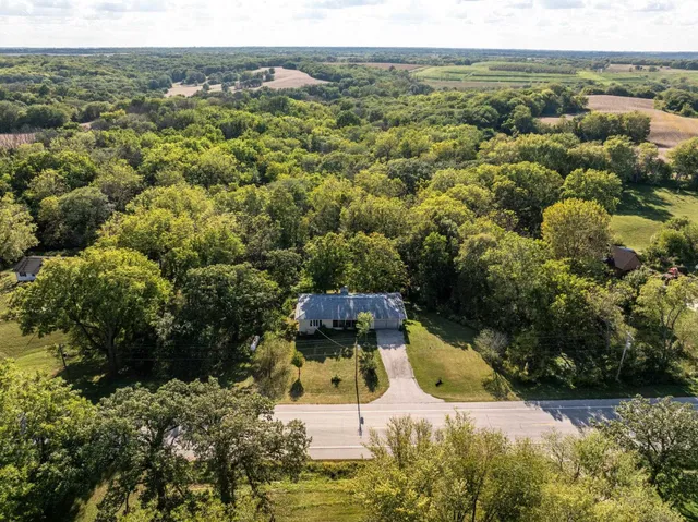 an aerial view of a house with a yard