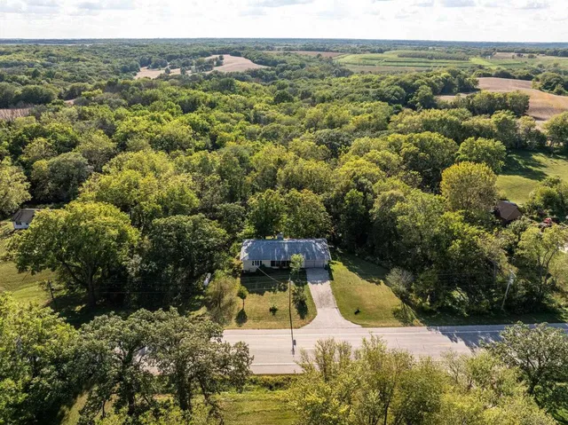 an aerial view of a house with a yard