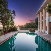 a view of swimming pool with seating area and trees around