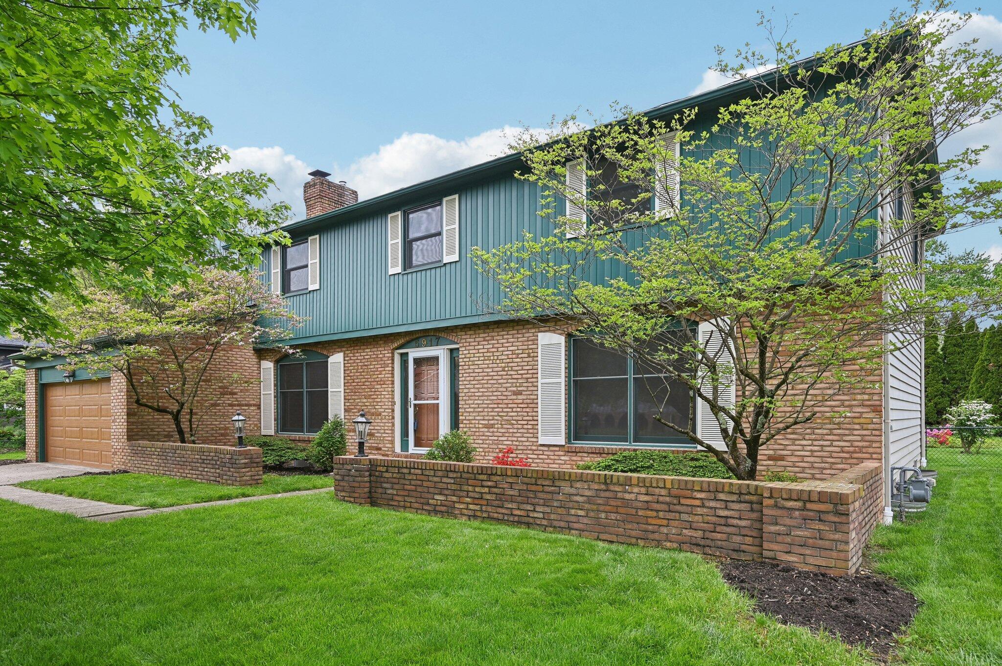 5917 Rocky Rill Road Columbus, OH 43235 - Photo 2 of 47 Front Exterior – Angled View
Classic architecture with brick façade, two-car garage, and landscaped front beds, showcasing the home’s timeless character.
