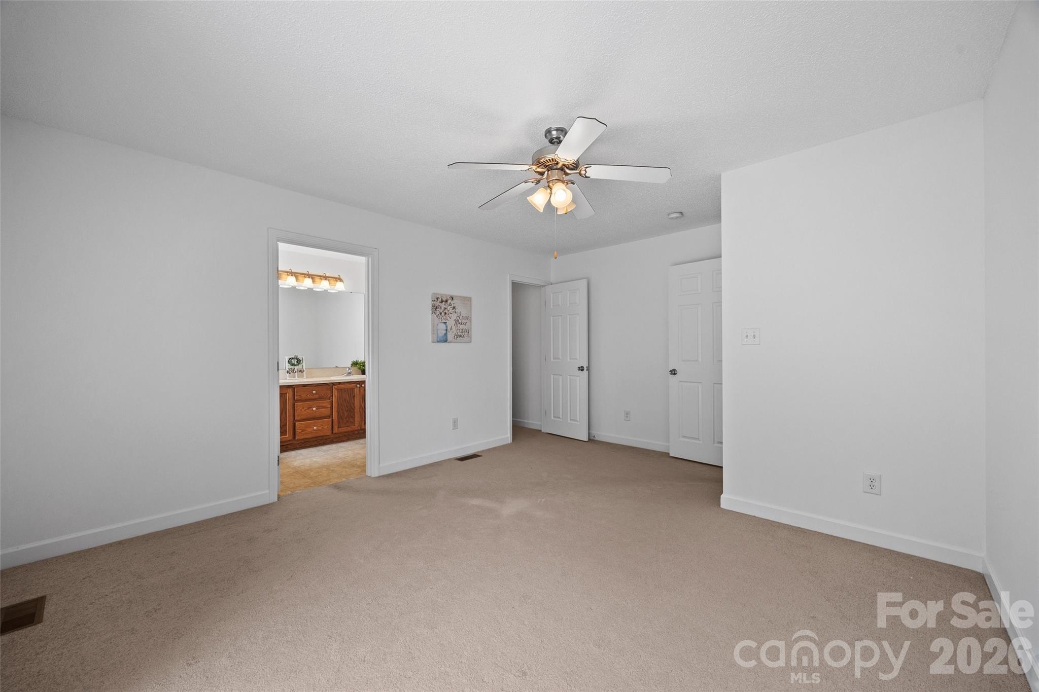 4660 Garys Place Crouse, NC 28033 - Photo 15 of 32 an empty room with chandelier fan and windows