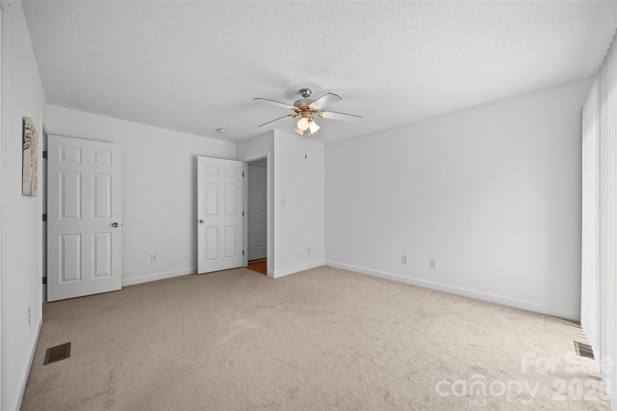 4660 Garys Place Crouse, NC 28033 - Photo 16 of 32 a view of an empty room with a ceiling fan