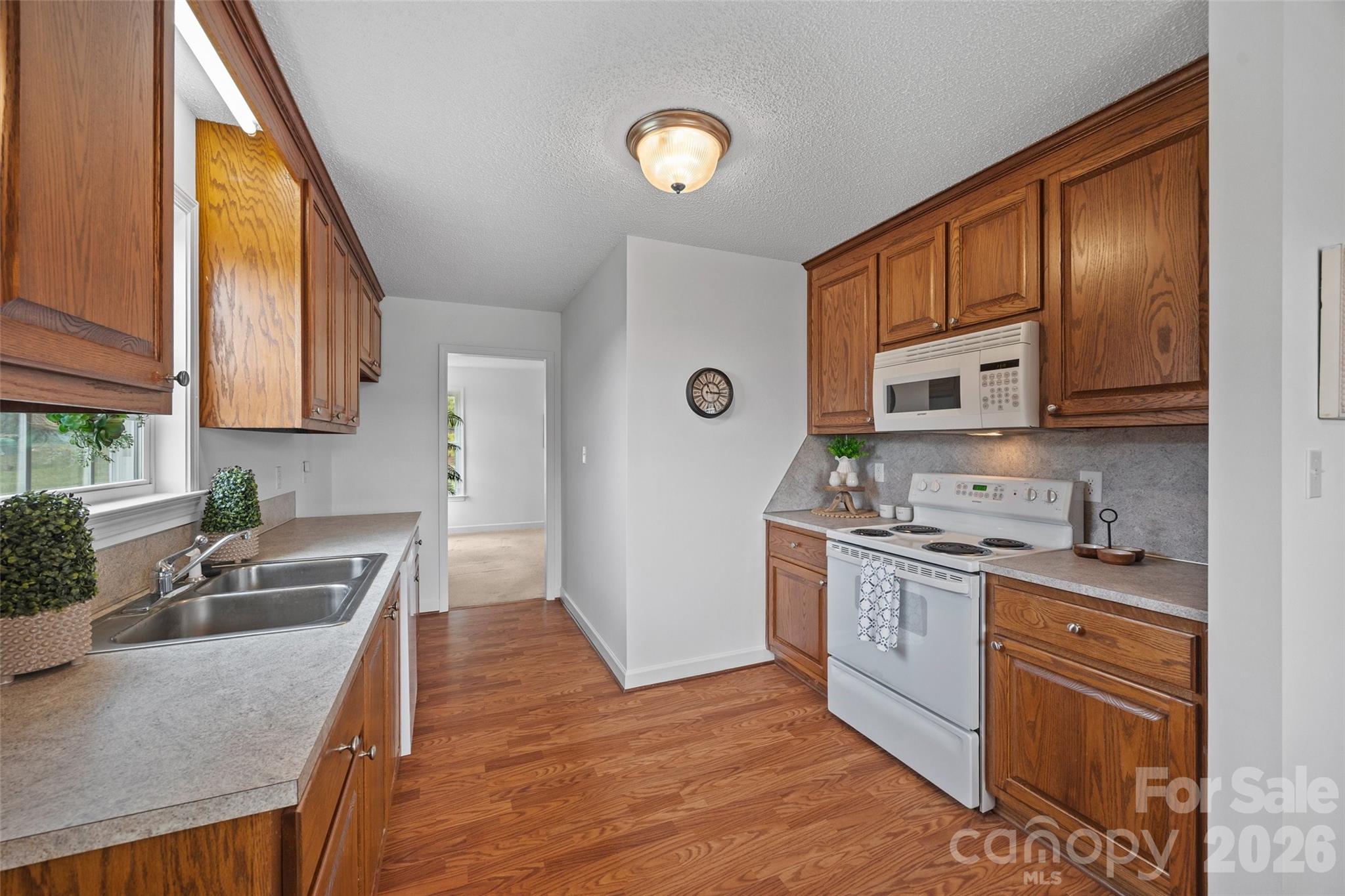 4660 Garys Place Crouse, NC 28033 - Photo 7 of 32 a kitchen with stainless steel appliances granite countertop a stove a sink dishwasher and a microwave oven with white cabinets