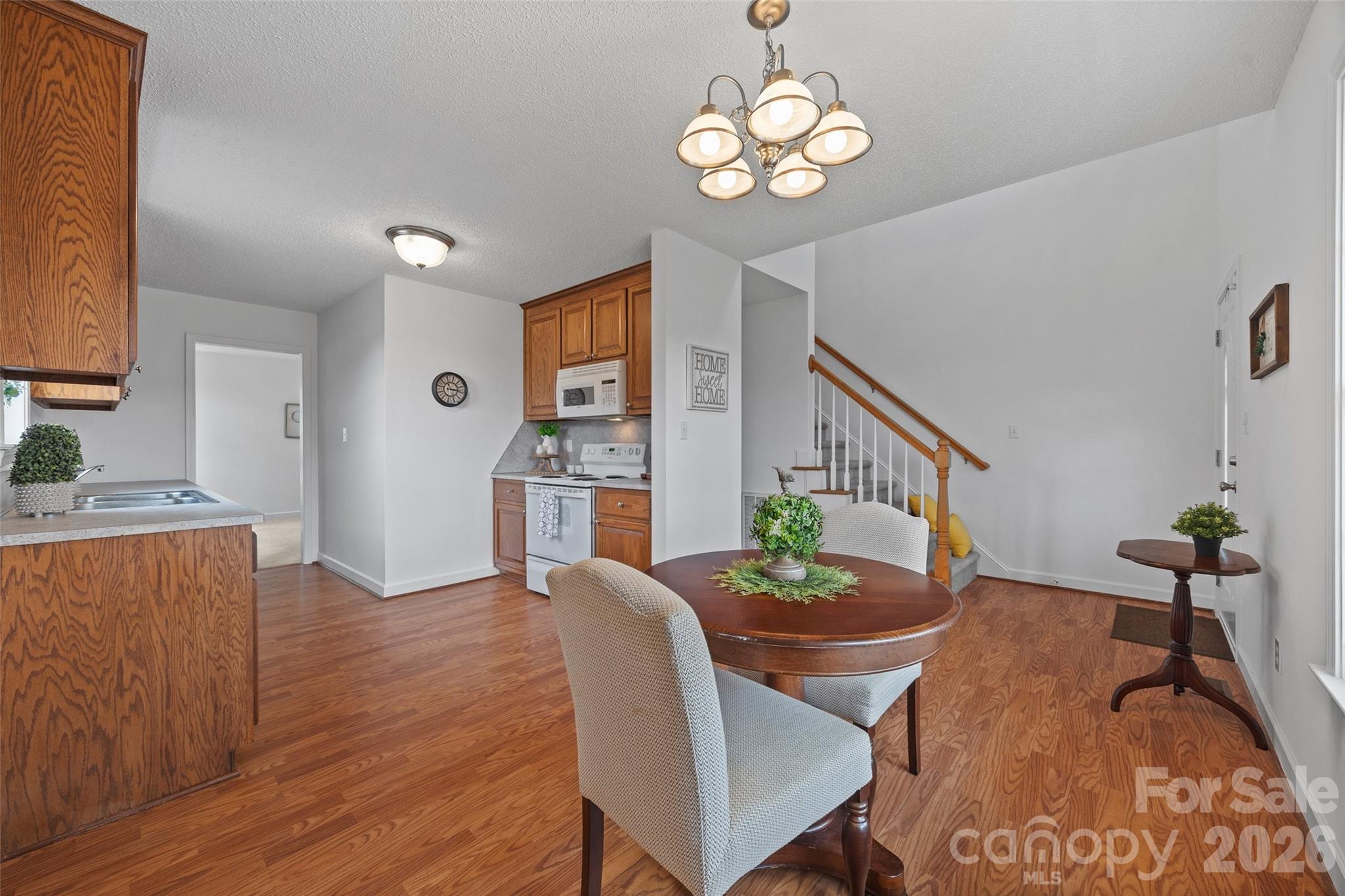 4660 Garys Place Crouse, NC 28033 - Photo 8 of 32 a view of a dining room with furniture wooden floor and chandelier