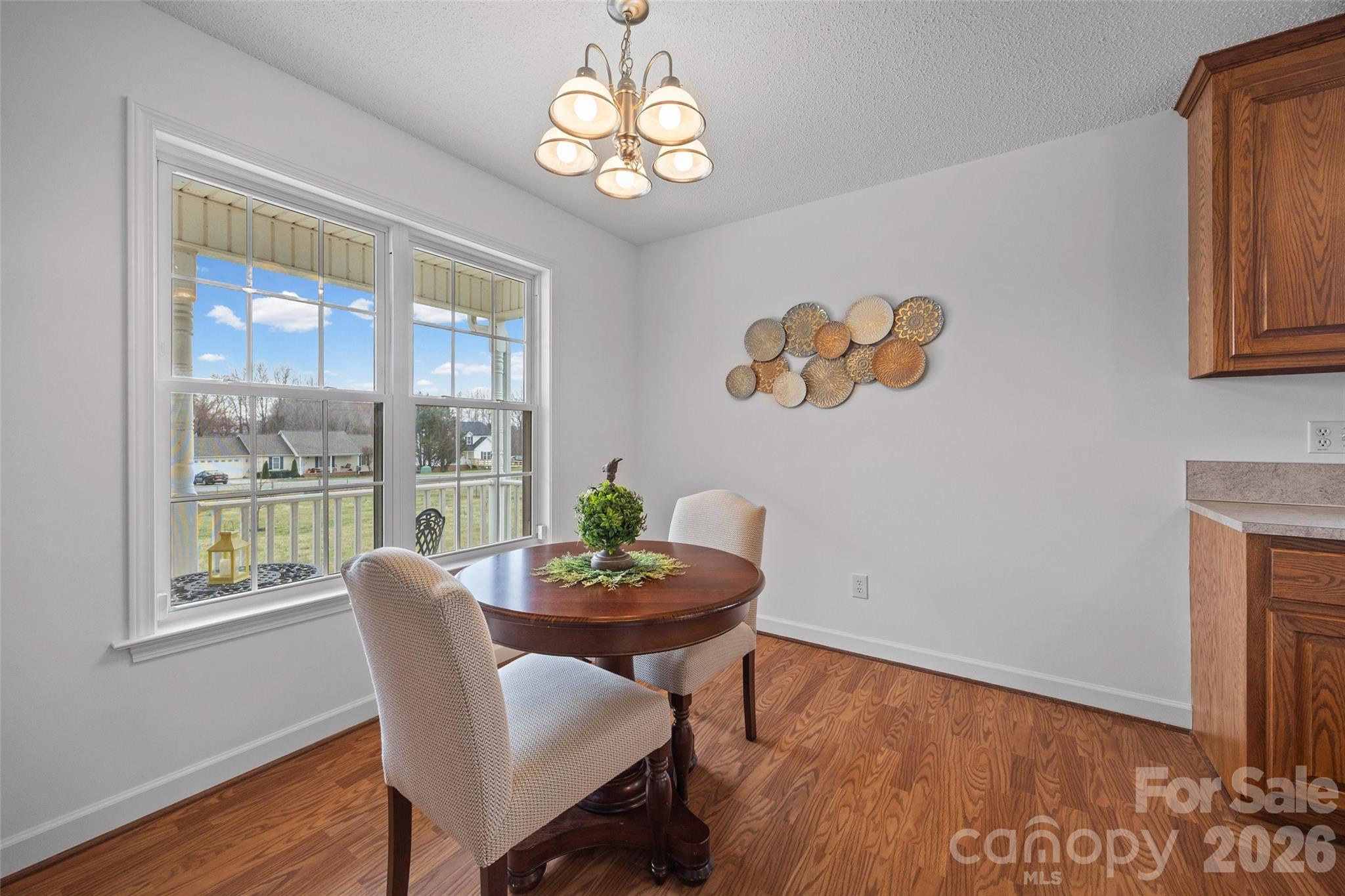 4660 Garys Place Crouse, NC 28033 - Photo 9 of 32 a view of a dining room with furniture a chandelier and wooden floor