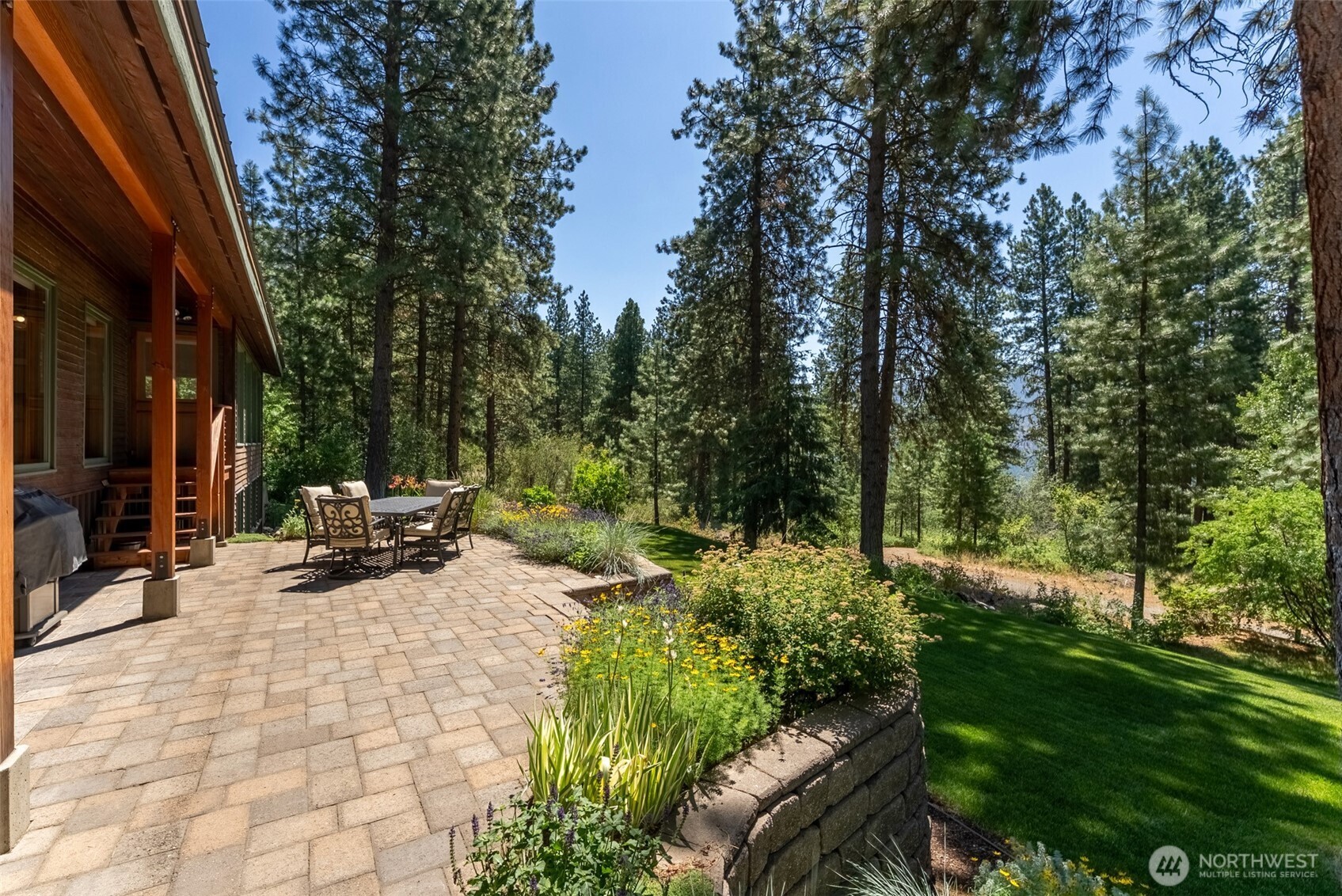 2 Trillium Road Winthrop, WA 98862 - Photo 31 of 40 a view of backyard with a table and chairs and potted plants