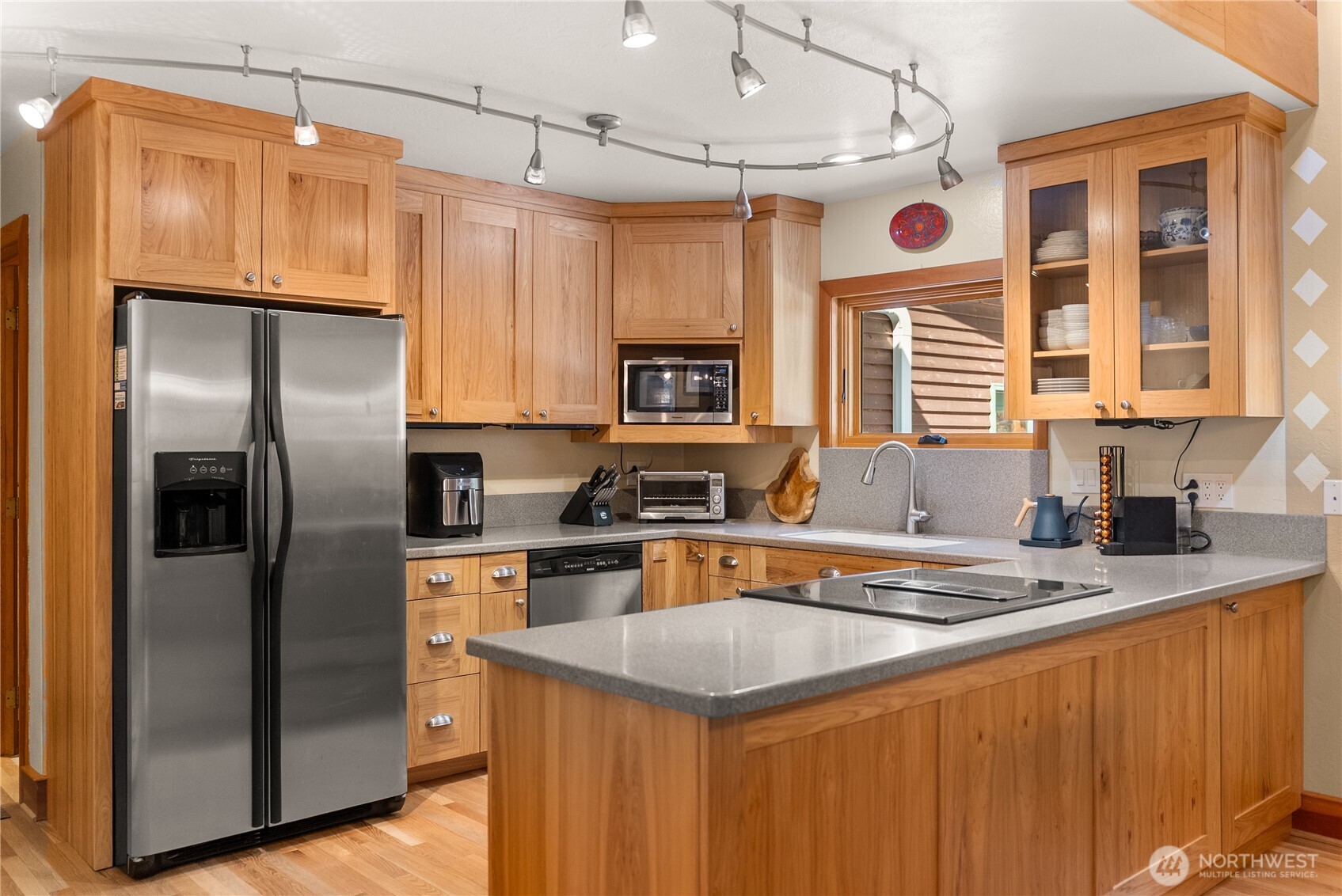 2 Trillium Road Winthrop, WA 98862 - Photo 10 of 40 a kitchen with stainless steel appliances granite countertop a refrigerator a sink dishwasher a stove and a dining table with wooden cabinet