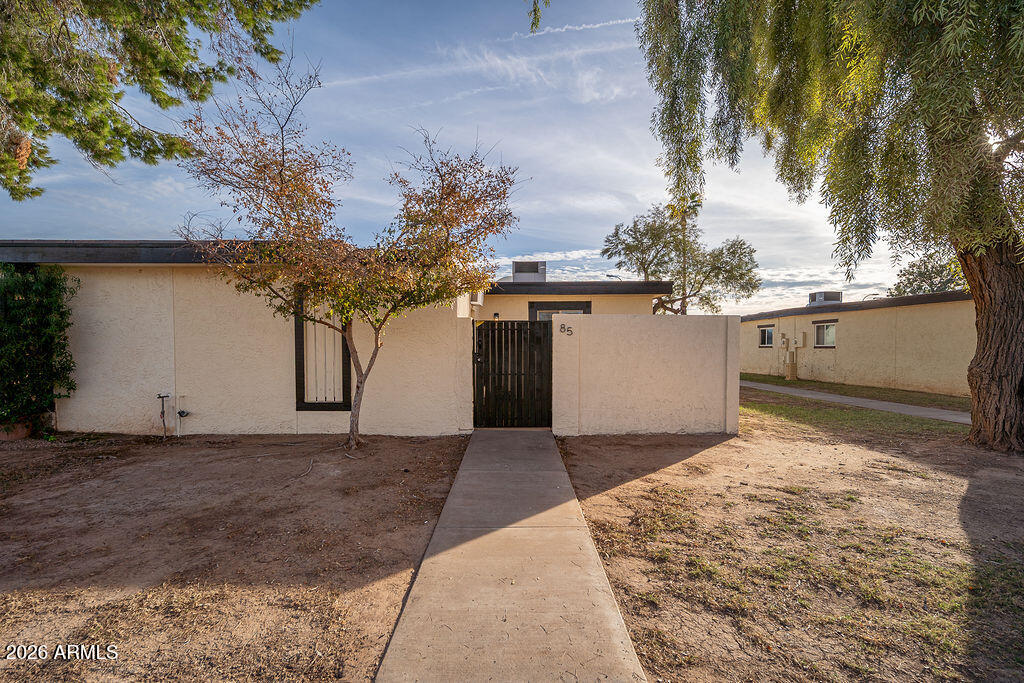 720 South Dobson Road, Unit 85 Mesa, AZ 85202 - Photo 15 of 16 a front view of a house with a yard and garage