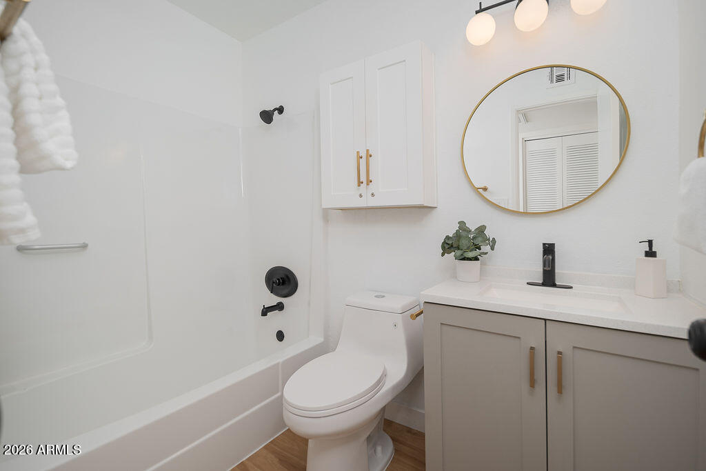 720 South Dobson Road, Unit 85 Mesa, AZ 85202 - Photo 10 of 16 a bathroom with a sink a toilet and a mirror