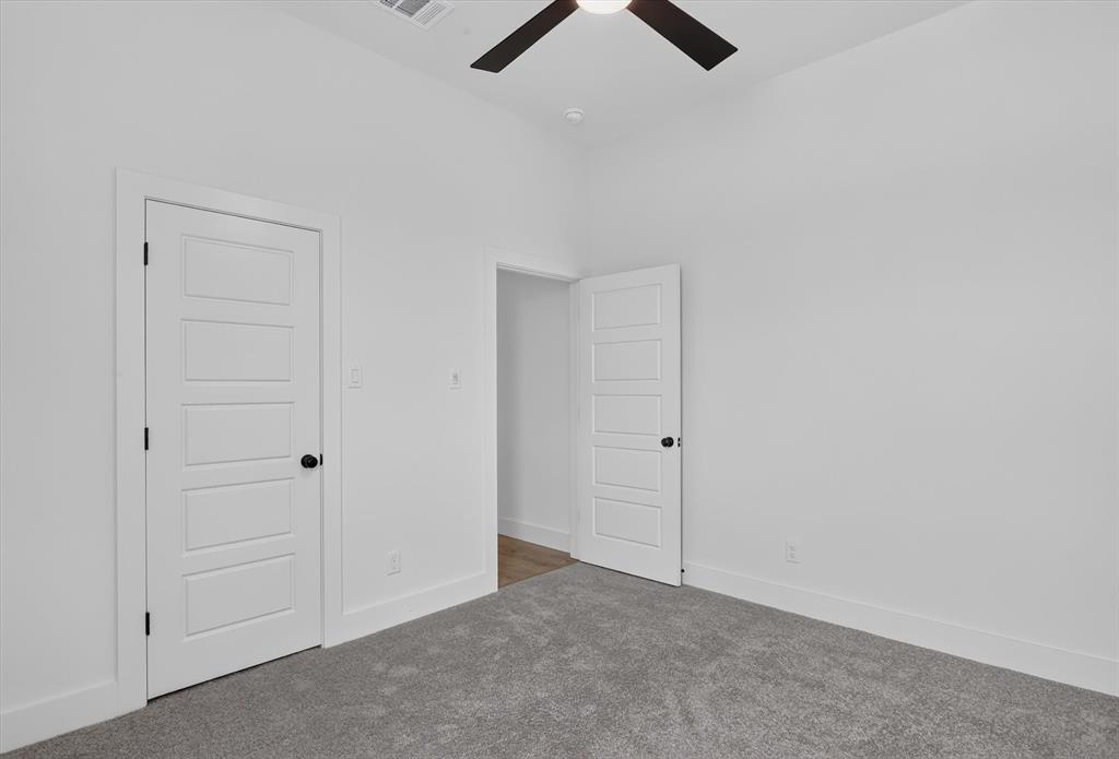 471 Red Bird Drive Springtown, TX 76082 - Photo 21 of 35 Spacious room featuring vaulted ceilings, a ceiling fan with integrated lighting, and light grey carpeting