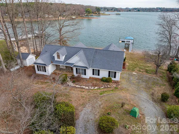 an aerial view of a house with a lake view