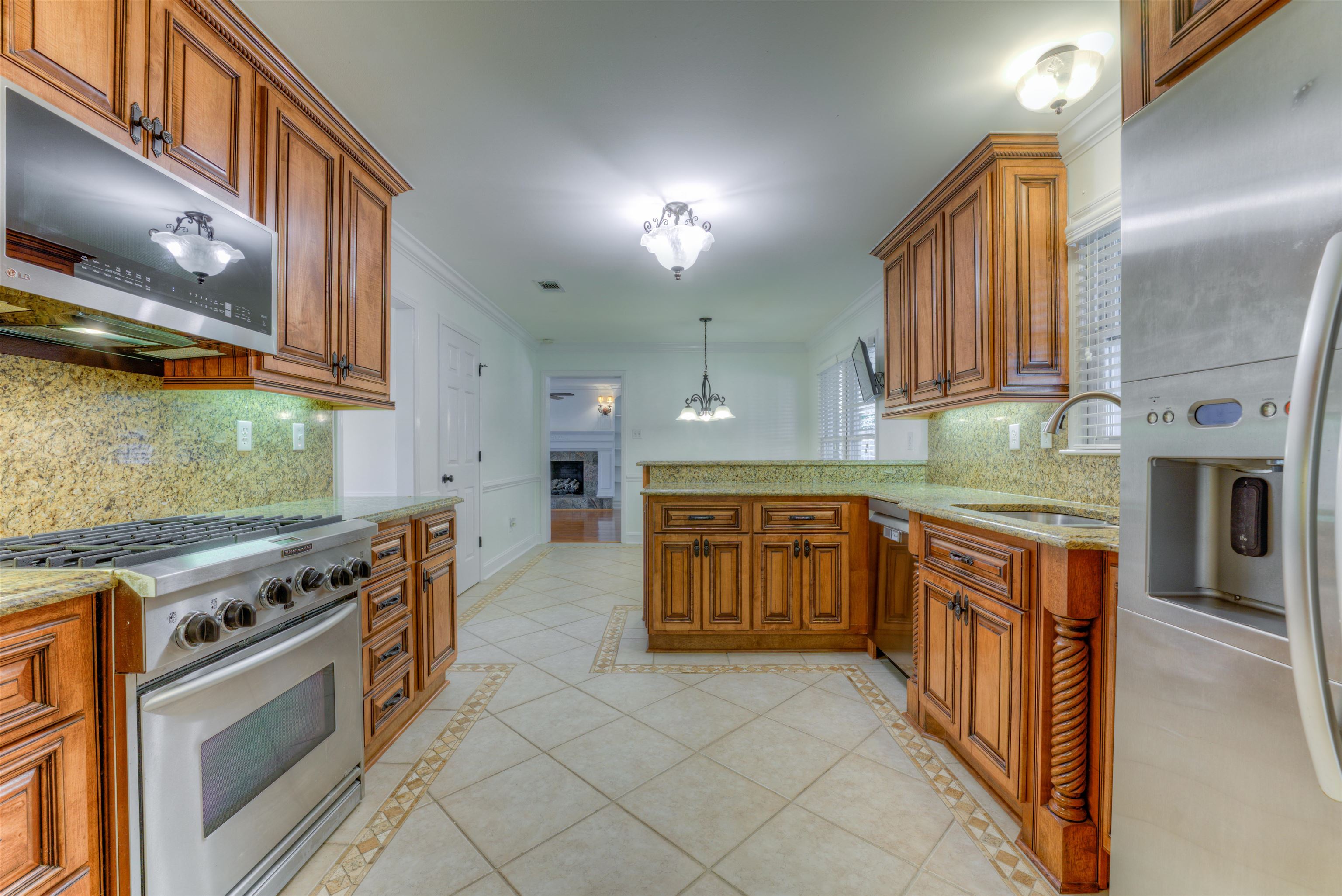 3385 Beaver Run Drive Collierville, TN 38017 - Photo 6 of 24 a kitchen with stainless steel appliances granite countertop a stove a sink and a microwave