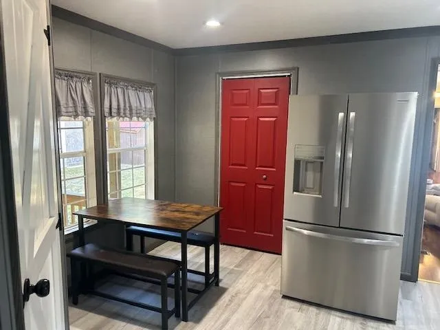 a kitchen with a refrigerator and a more cabinets