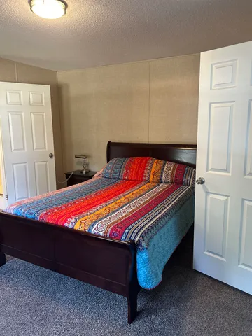 a bed sitting in a bedroom next to a window