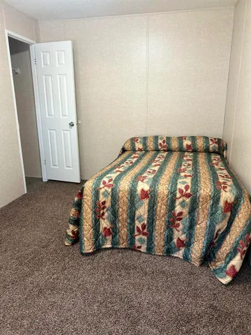 a bedroom with bed and a window