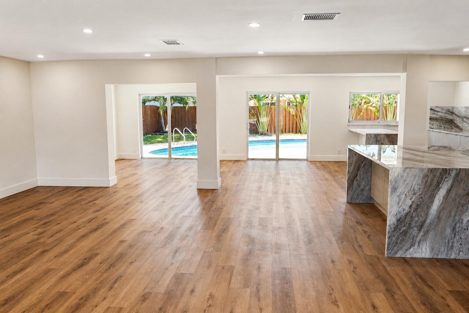 4815 Cleveland Street Hollywood, FL 33021 - Photo 6 of 31 a view of an empty room with wooden floor and a window