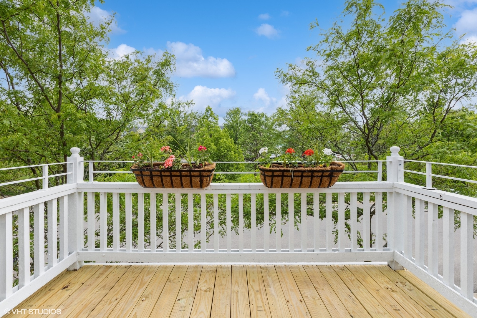 a view of a wooden deck and a yard