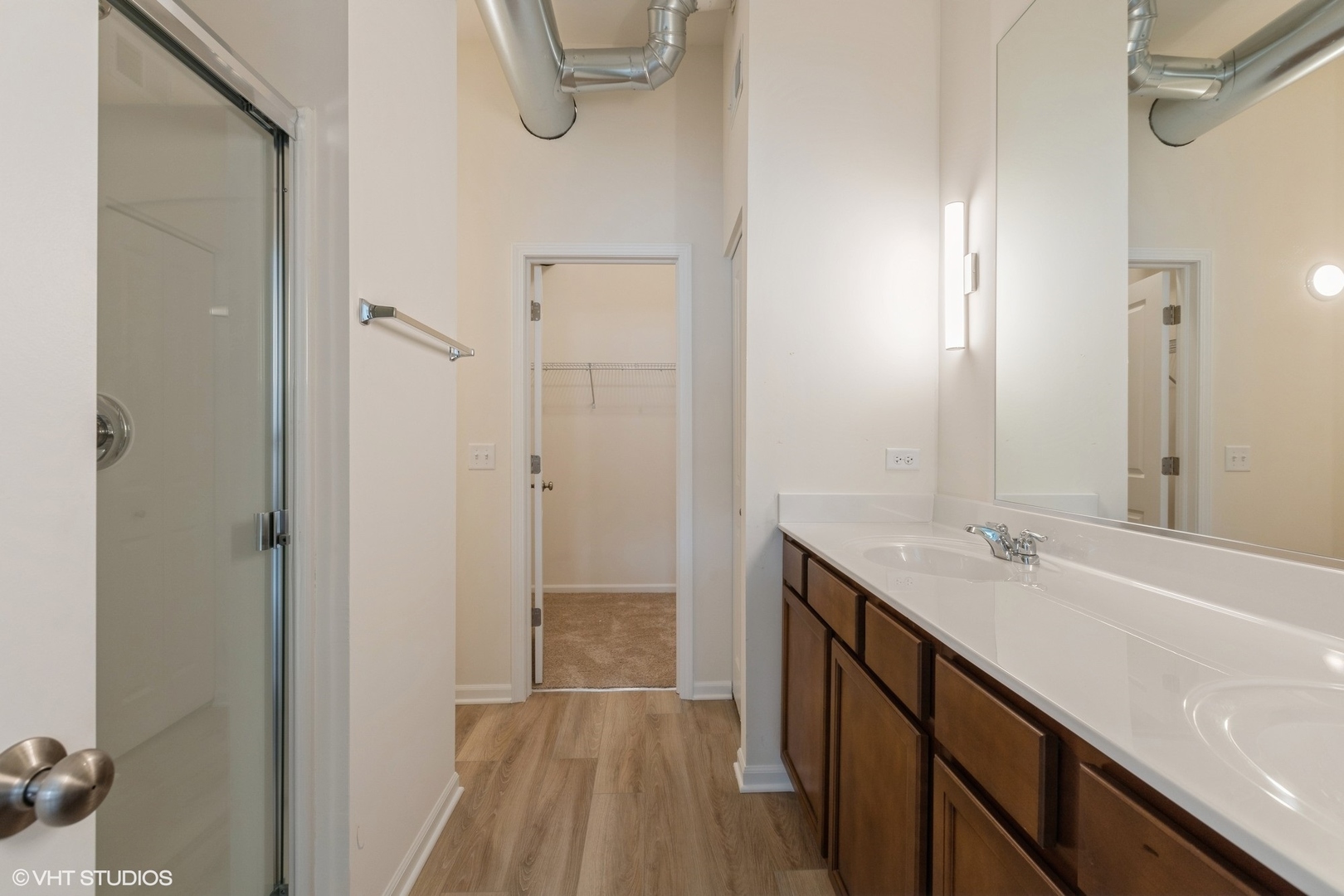 1690 Simms Street Aurora, IL 60504 - Photo 12 of 24 a bathroom with a sink a mirror and a shower