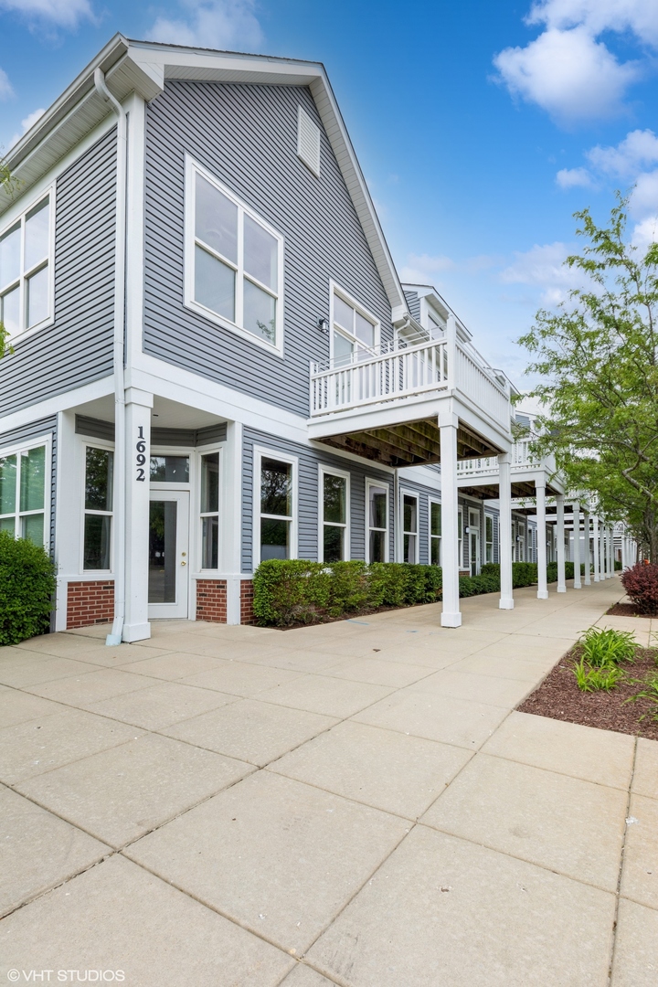 1690 Simms Street Aurora, IL 60504 - Photo 3 of 24 a front view of a house with a yard