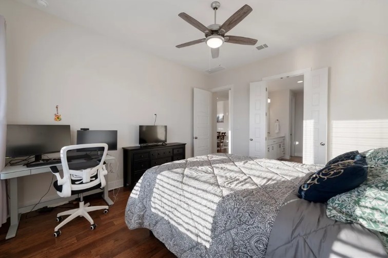 344 Pisa Lane Georgetown, TX 78628 - Photo 31 of 39 Rich hardwood flooring anchors this comfortable bedroom suite with an adjoining bath.
