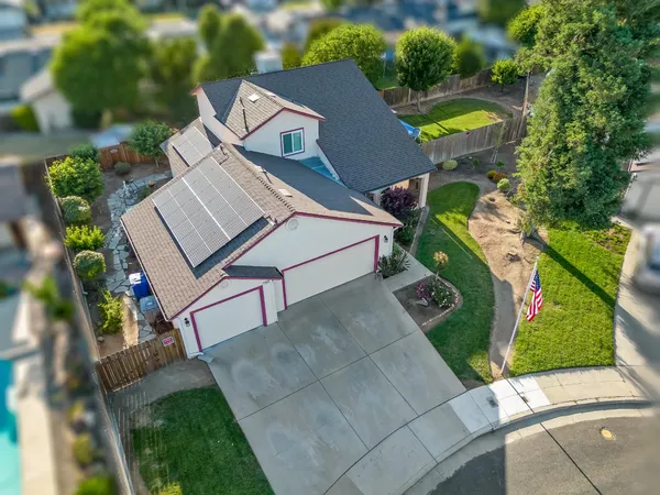 a view of a house with a yard and sitting area